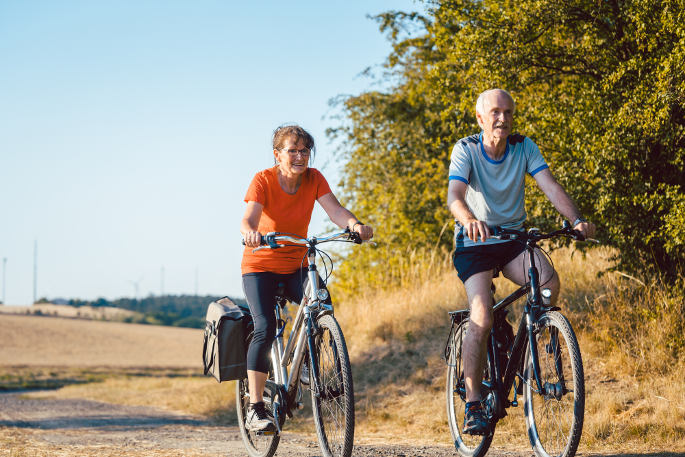 Senior couple riding their bicycles for better fitness and health benefits